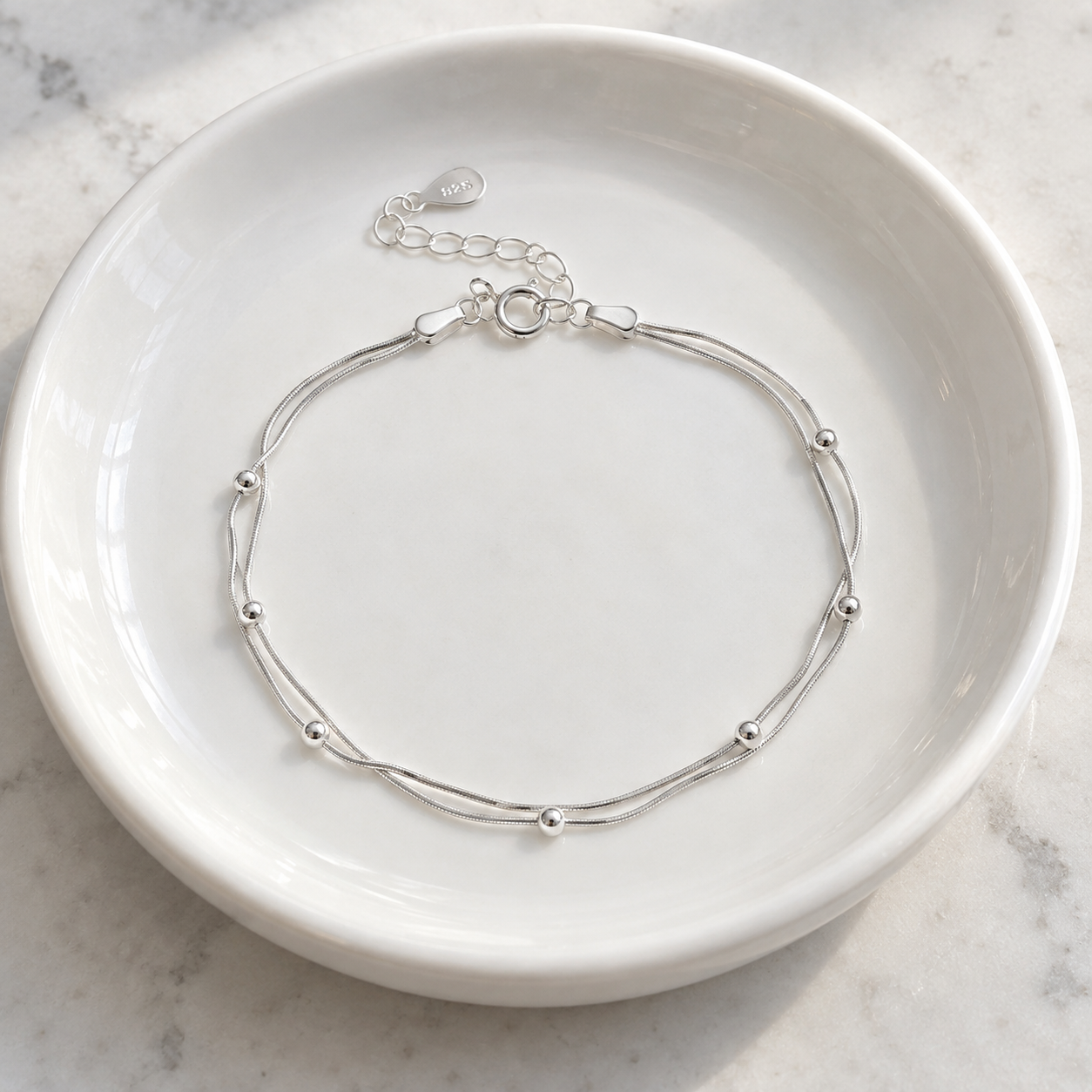 Florence Leaf Bracelet resting in a white ceramic basin; basin not included