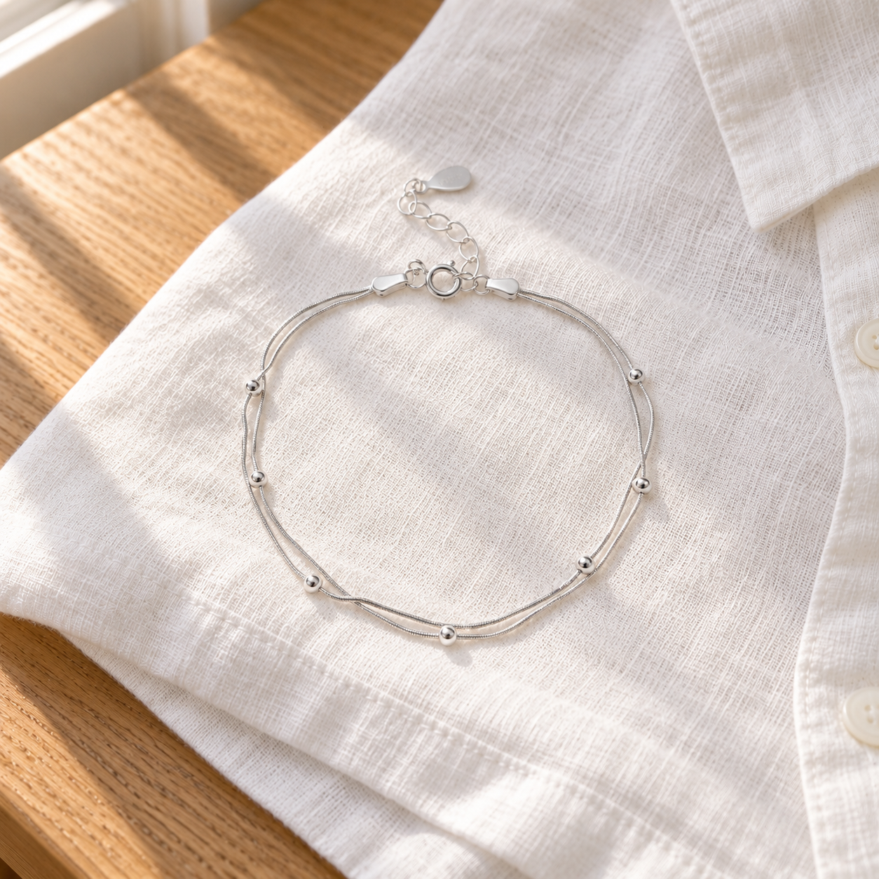 Florence Leaf Bracelet resting on white linen; styling props not included