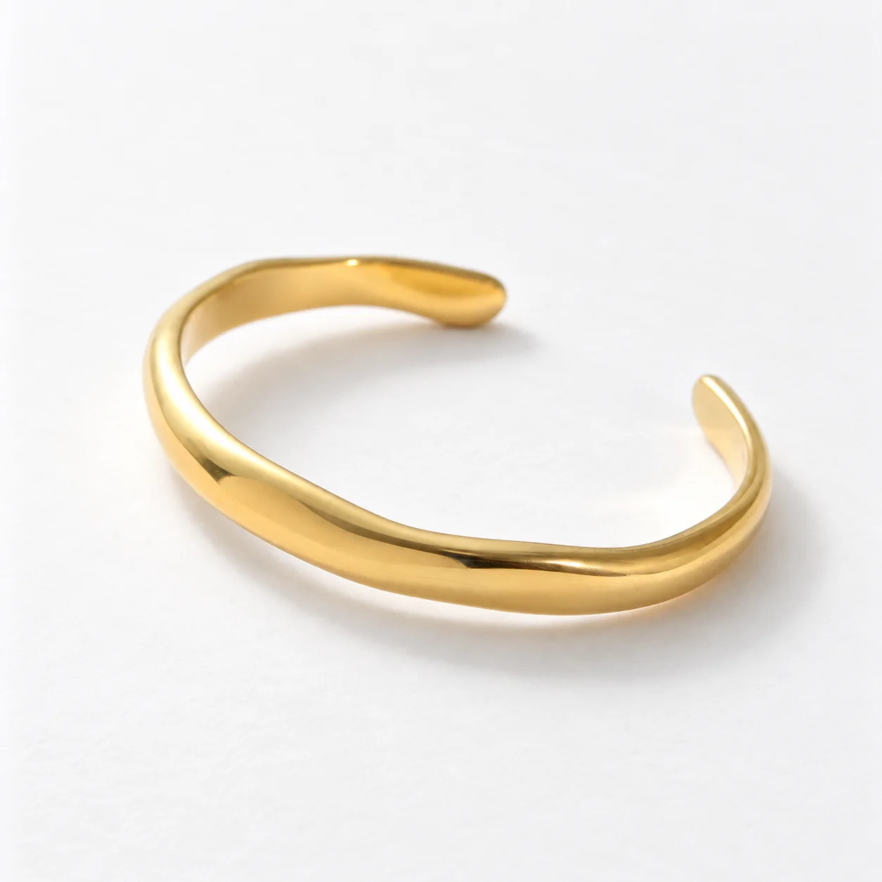 Gold-tone Sculpted Cuff with an open oval shape and rounded ends