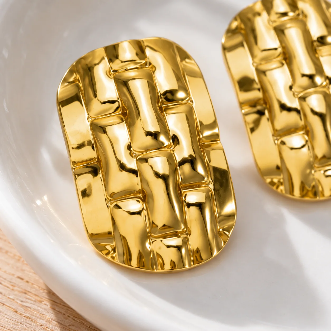 EH060 gold-colored woven rectangular stud earrings: detail view; other styling items not included