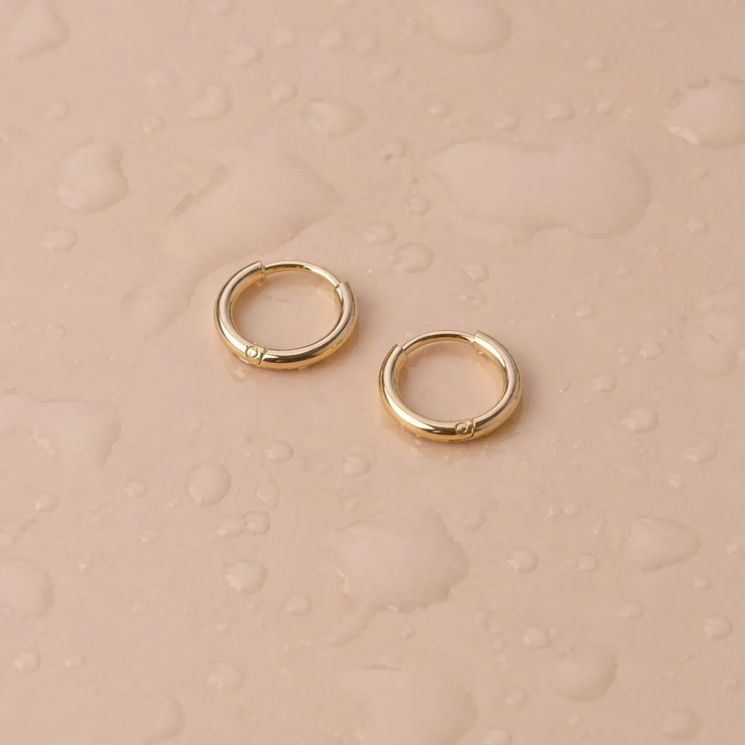 Tiny Huggie Hoops - reviewed gold-color source photograph