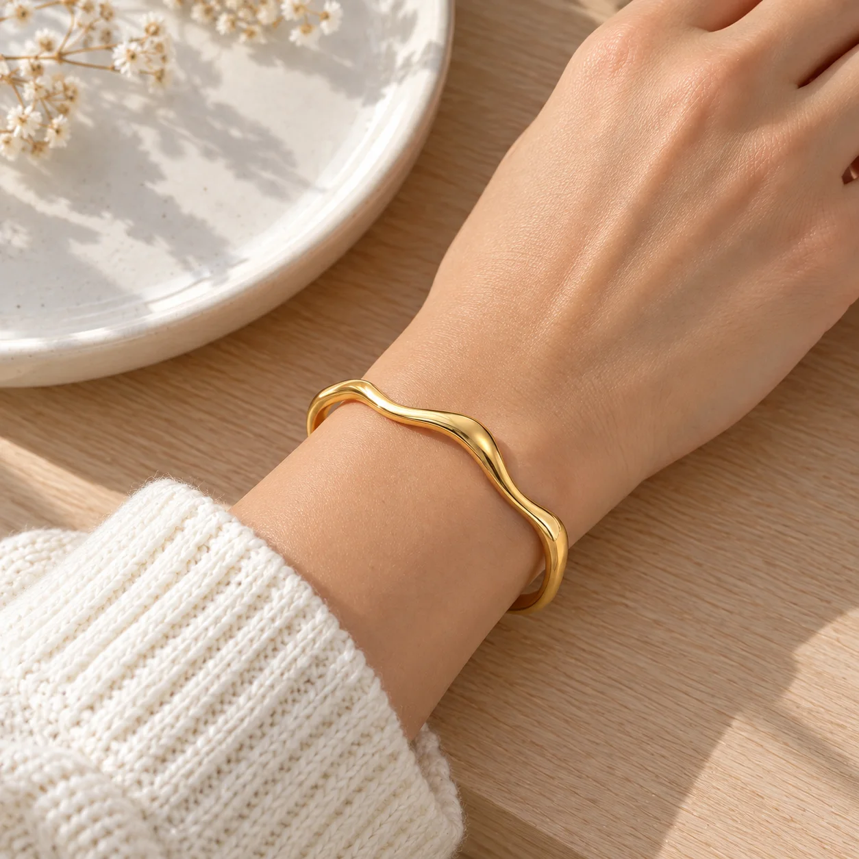 Gold-colored narrow wavy open stainless steel cuff JDB2405015: use view; other styling items not included