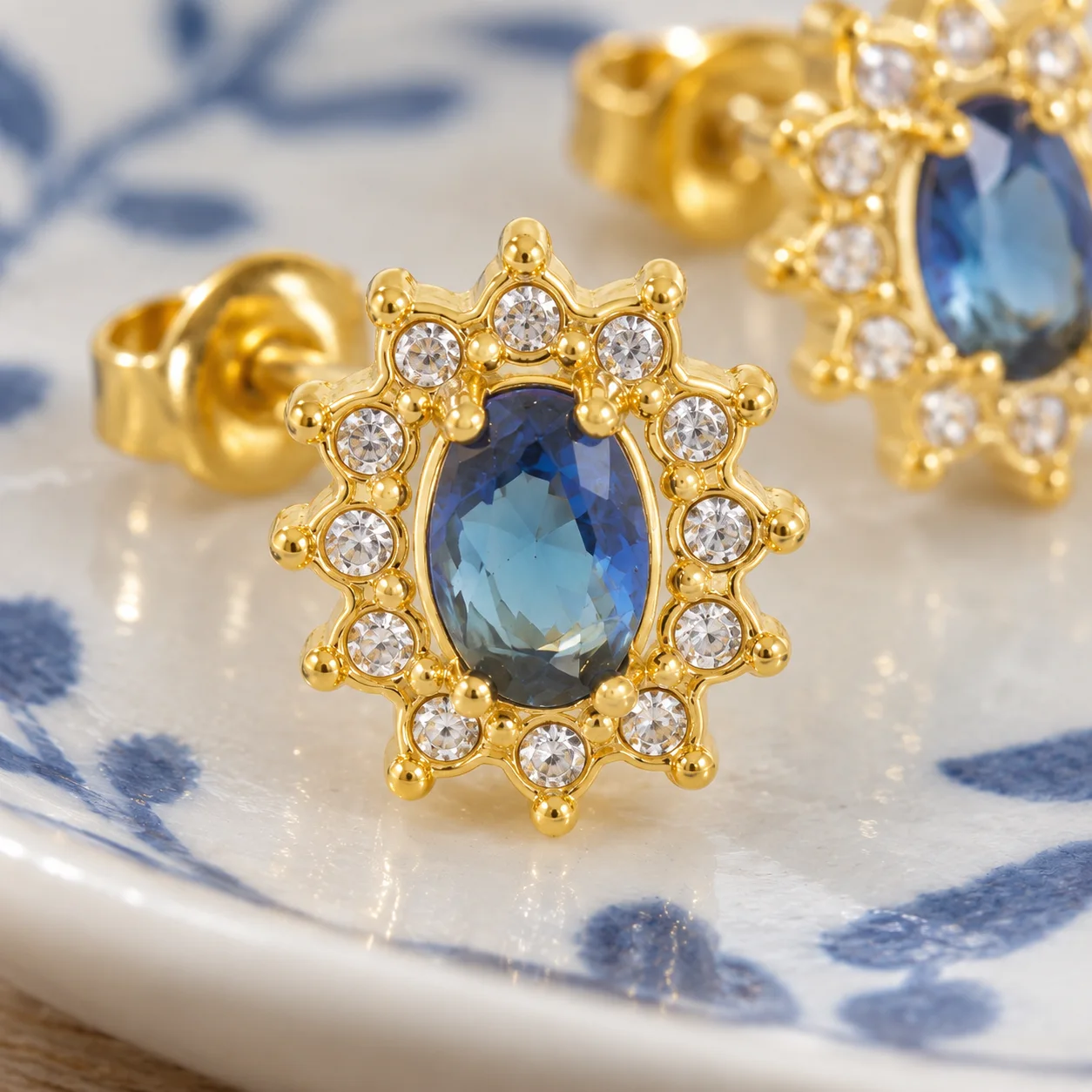 Blue oval stone sunflower stud earrings: detail view; other styling items not included