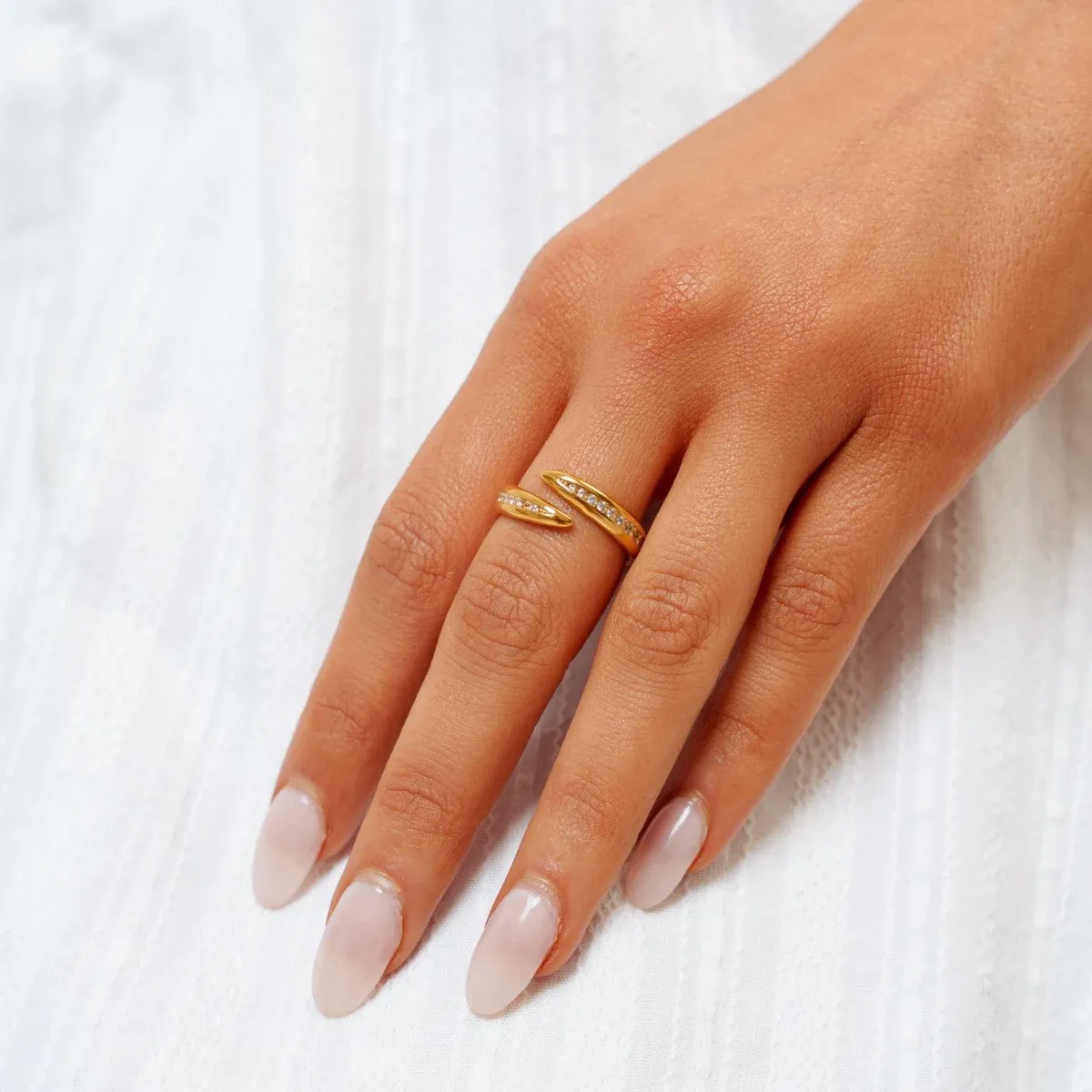 Stella Wrap Ring worn alone on a hand, showing both tapered zirconia-set ends