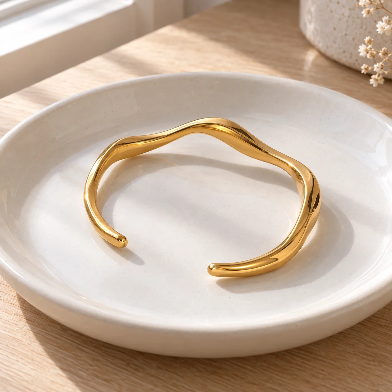 Gold-colored narrow wavy open stainless steel cuff JDB2405015: lead view; other styling items not included
