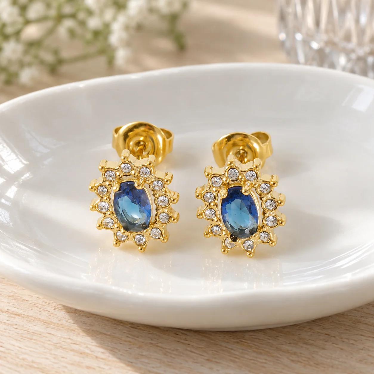 Blue oval stone sunflower stud earrings: lead view; other styling items not included