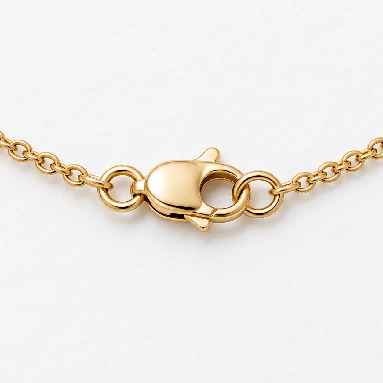 Lobster clasp and connecting rings in close view